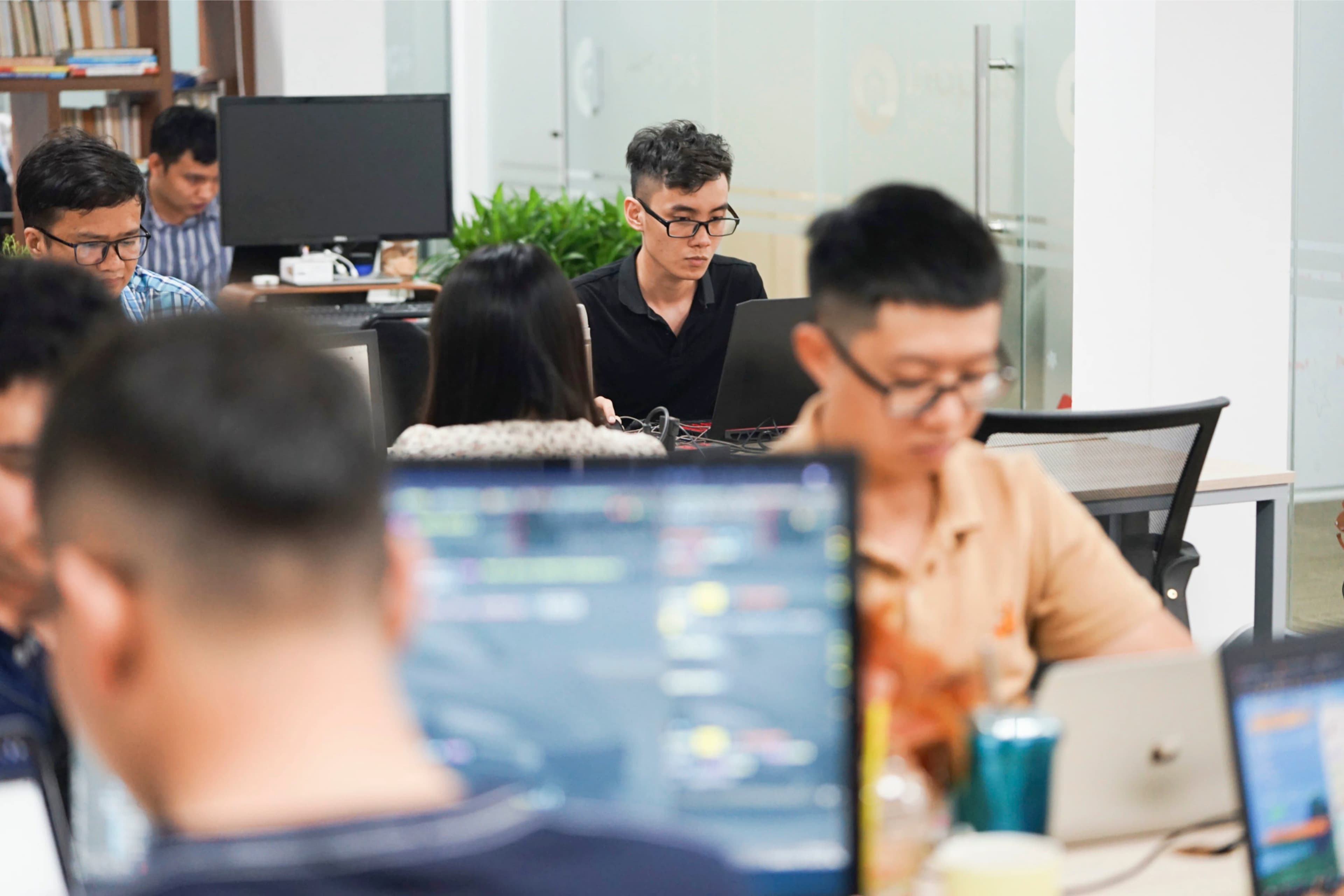 InApps engineering team collaborating in a modern office with orange accent lighting