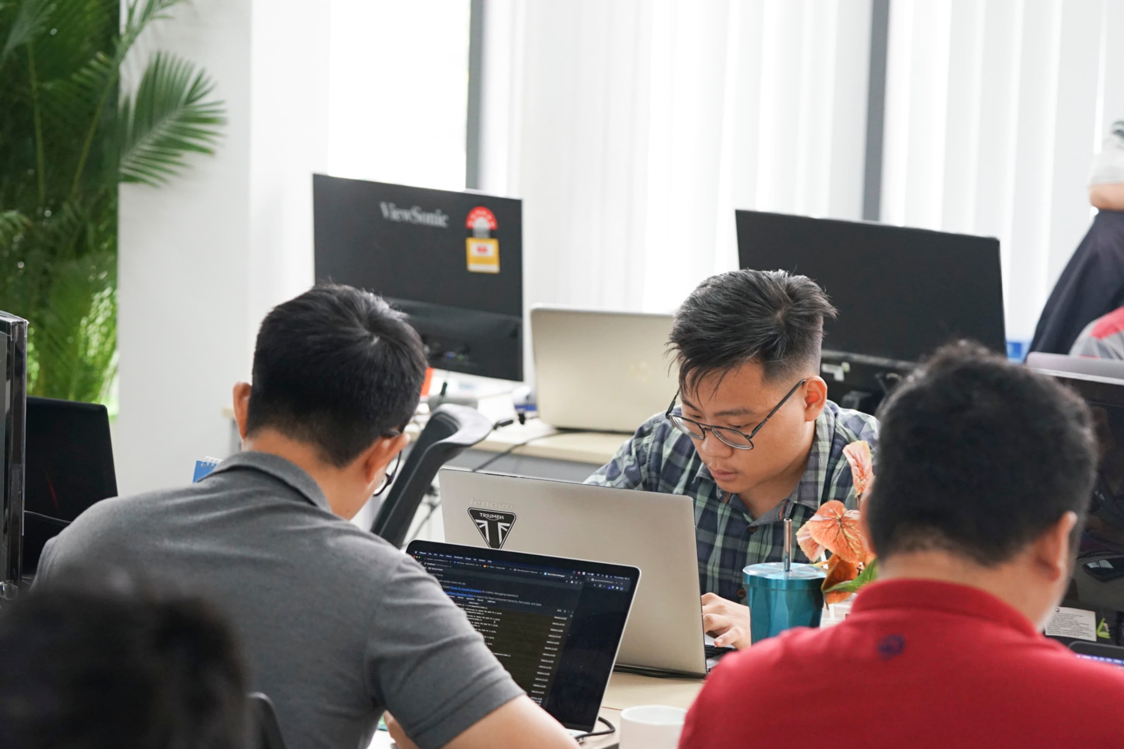 InApps Technology offshore software development team working at their desks in a modern open-plan office in Vietnam